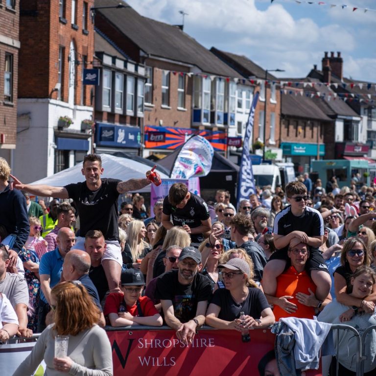 Crowd gathering at festive event Newport Carnival, with people celebrating and enjoying the atmosphere.